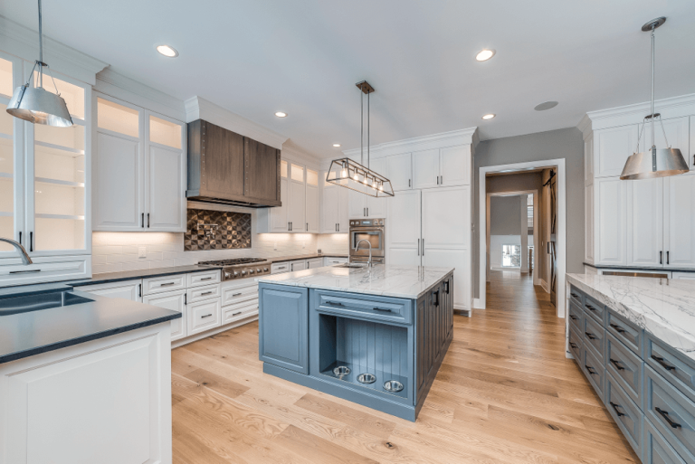 beautiful-kitchen-scene-white-granite-counter-blue-accent-cabinet